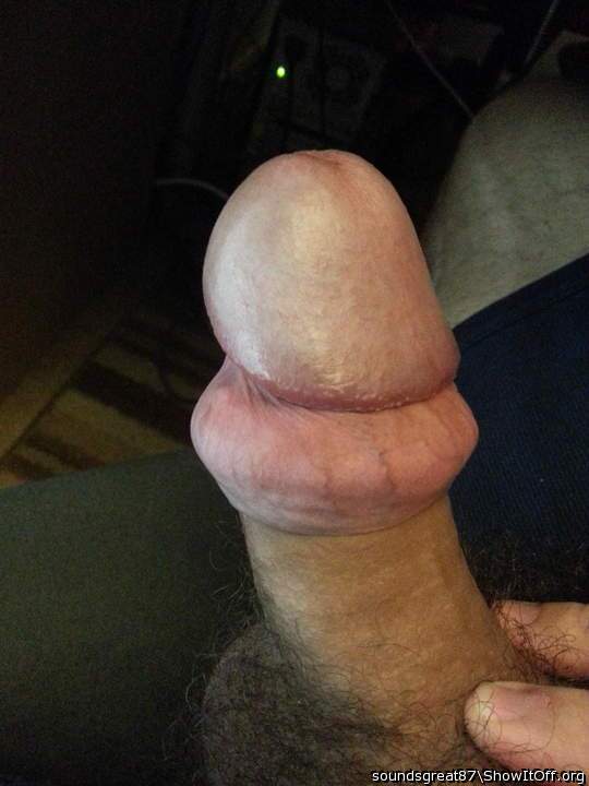 Foreskin rolled back over cockring, still