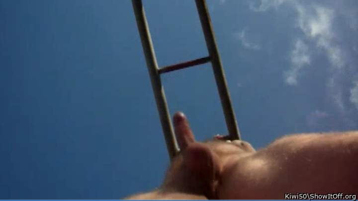 Up shot under monkey bars on blue sky day.
