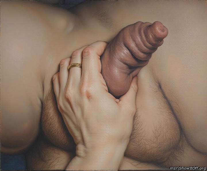 A woman's hand squeezes an uncircumcised cock with foreskin