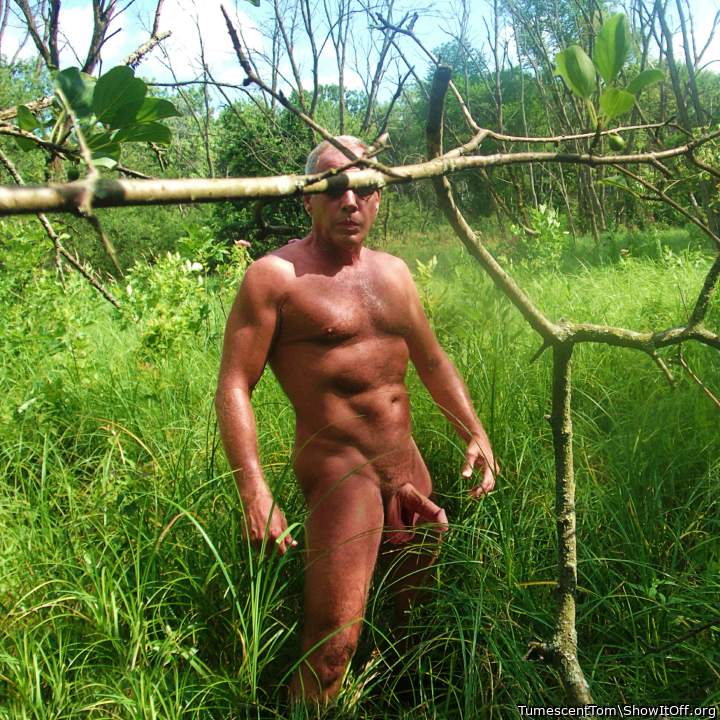 Naked outdoors one hot and sunny day.