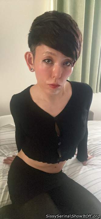 Sissy Serina is wearing a black cardigan, tight skirt and pantyhose