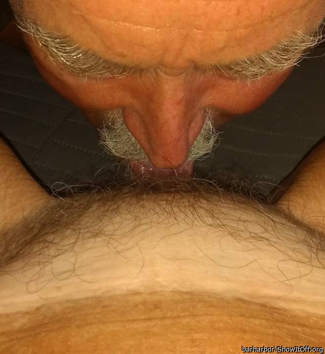 Teasing her swollen clit.
