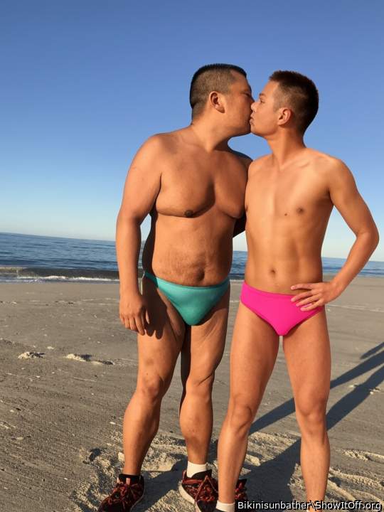 Kissing at the beach in our bikinis