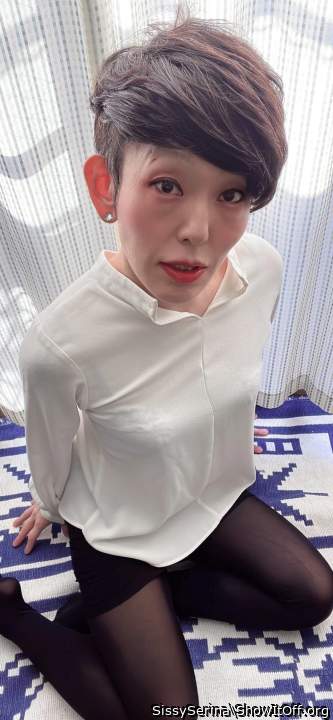 Serina in a white blouse and black pantyhose